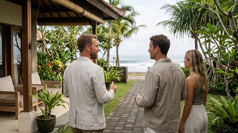 A property adviser and two buyers inspecting a coastal villa terrace in Bali