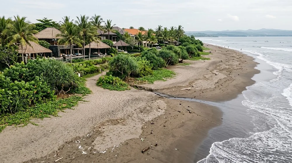 A Bali coastline with a public beach path and villas behind coastal vegetation